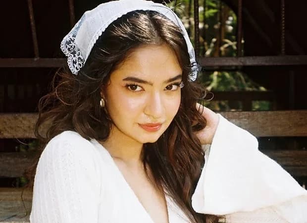 Anushka Sen at a film festival, smiling at the camera.