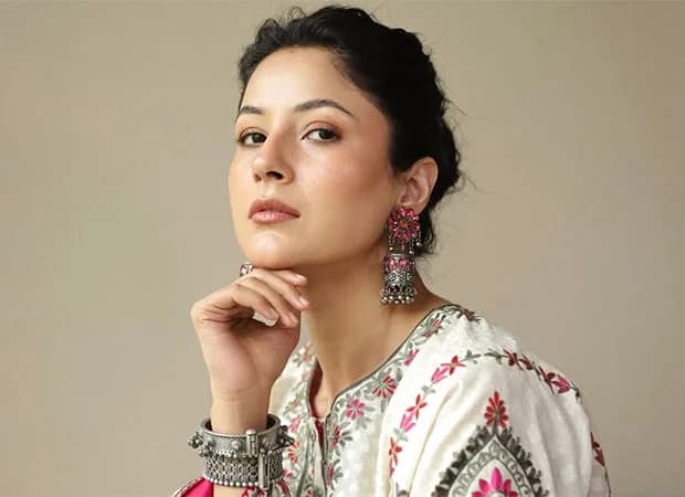 Shehnaaz Gill smiling during interview, wearing a casual outfit