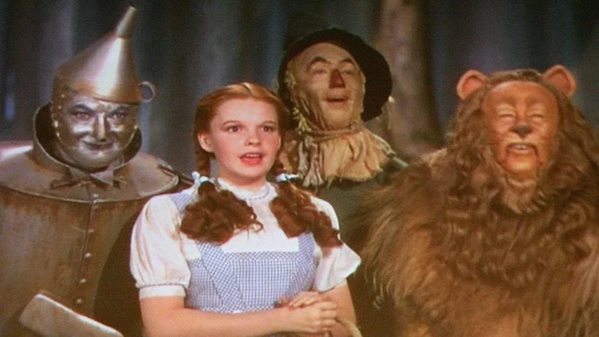 A still from The Wizard of Oz featuring Dorothy in her ruby slippers, standing in front of the Emerald City.