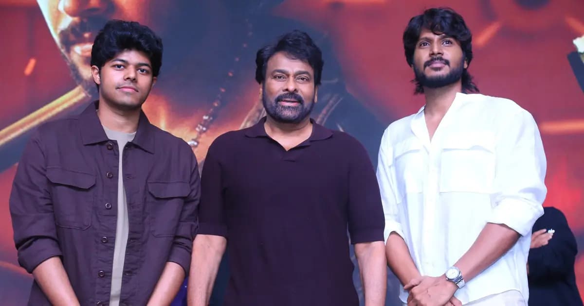 Chiranjeevi standing beside director Jason Sanjay at the Sigma pre‑release event in Hyderabad