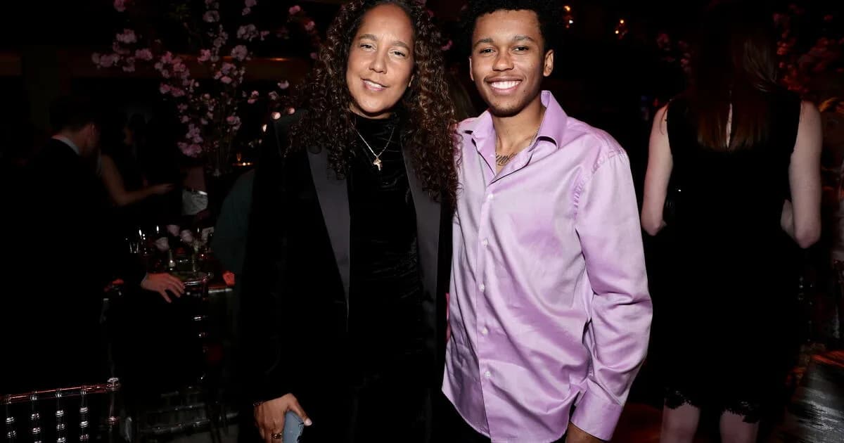 Cassius Bythewood stands with a Miami Police hero award while Gina Prince-Bythewood watches nearby.