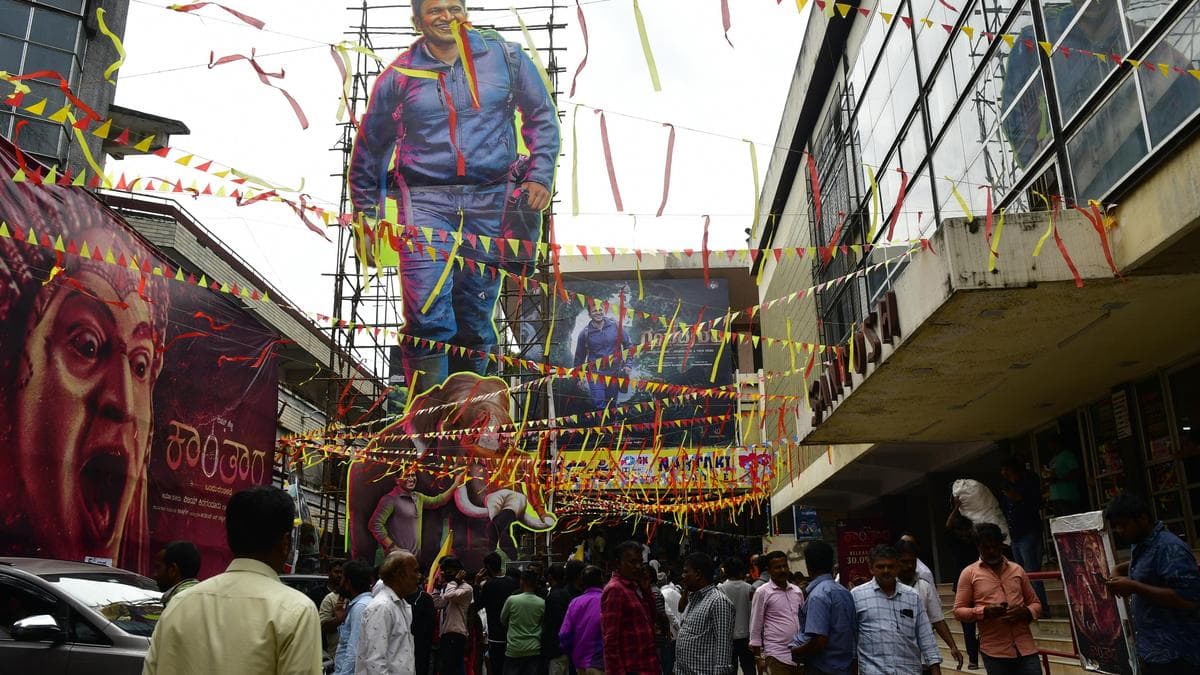 A crowd at a theatre in Bengaluru, watching a movie on a Monday afternoon. The poster reads 'Maa Inti Bangaaram'.