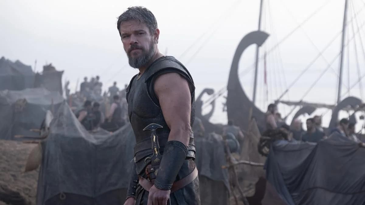 A still from Christopher Nolan’s The Odyssey featuring Matt Damon as Odysseus, standing amid stormy waves under a dark sky.