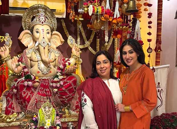 Sara Ali Khan poses beside a decorated Ganpati idol at a family celebration.