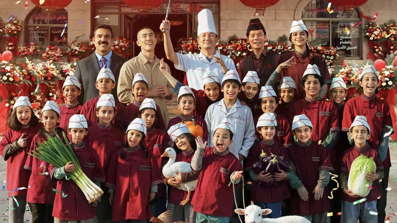 A still from the trailer showing a chef in a kitchen amid chaos, with a sign reading 'Welcome to the Loong Restaurant' visible behind him.