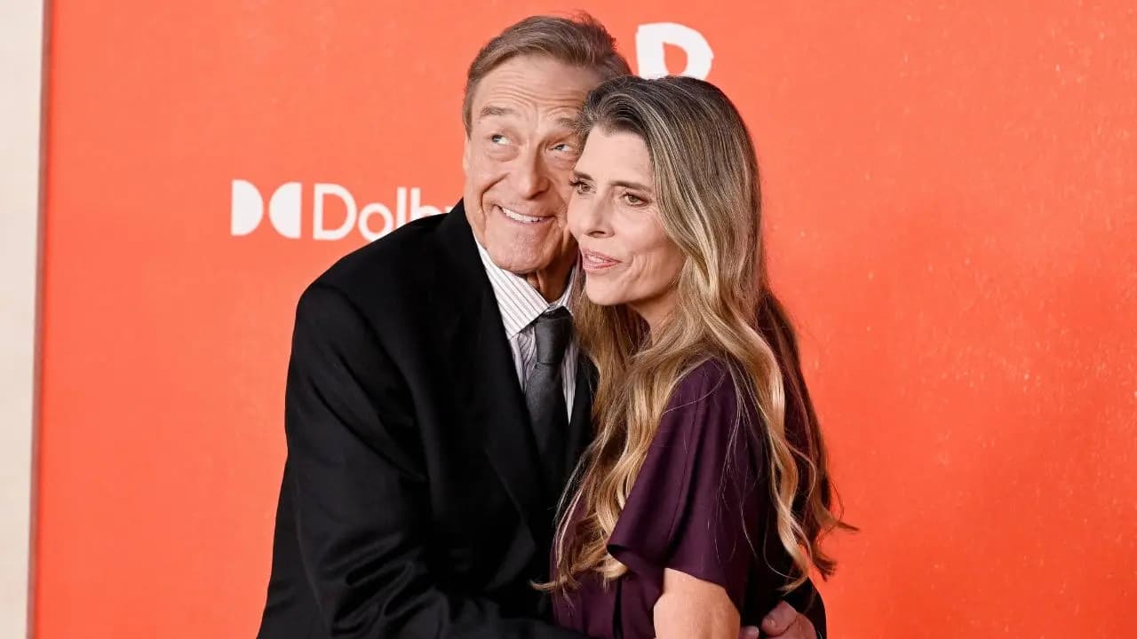 John Goodman in a black suit and Anna Beth in a plum dress on the Digger red carpet