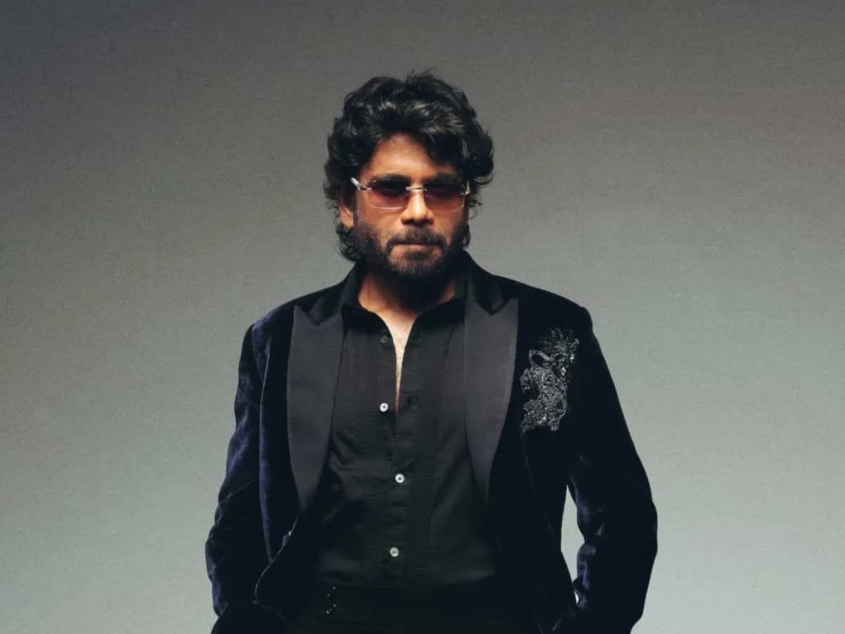 A black-and-white image of Nagarjuna Akkineni in profile, looking straight ahead, with the text 'King 100' overlaid in bold white font.