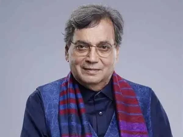 Subhash Ghai speaking at Whistling Woods International, surrounded by posters of classic Bollywood films.