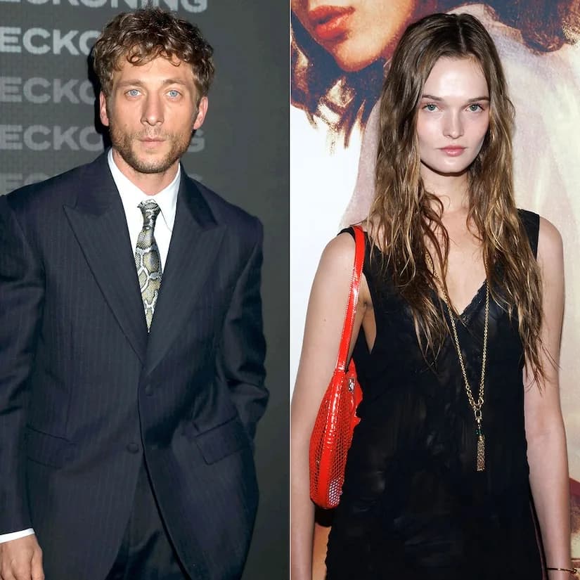 Jeremy Allen White and Lulu Tenney walking hand-in-hand in a New York City park