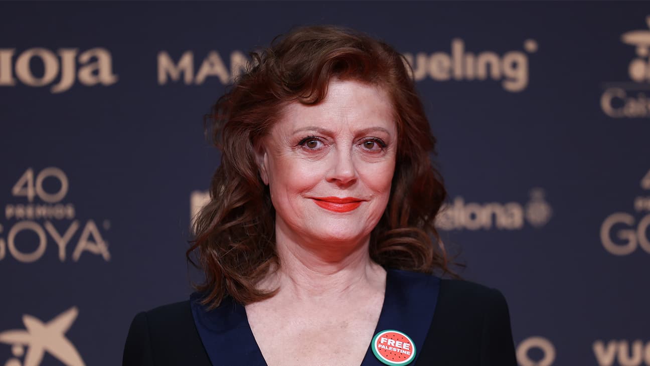 Susan Sarandon speaking at a press conference microphone at the Venice Film Festival