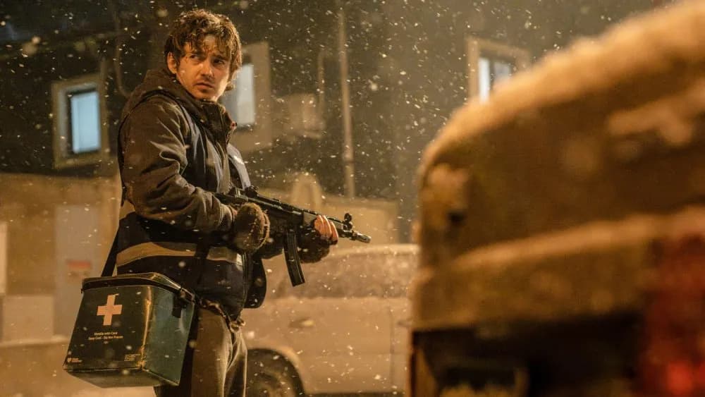 Poster of Resident Evil reboot featuring Austin Abrams in a blood‑splattered Raccoon City hospital corridor