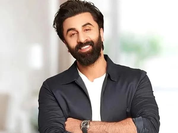 Ranbir Kapoor smiling at a birthday gathering alongside Alia Bhatt and Vicky Kaushal