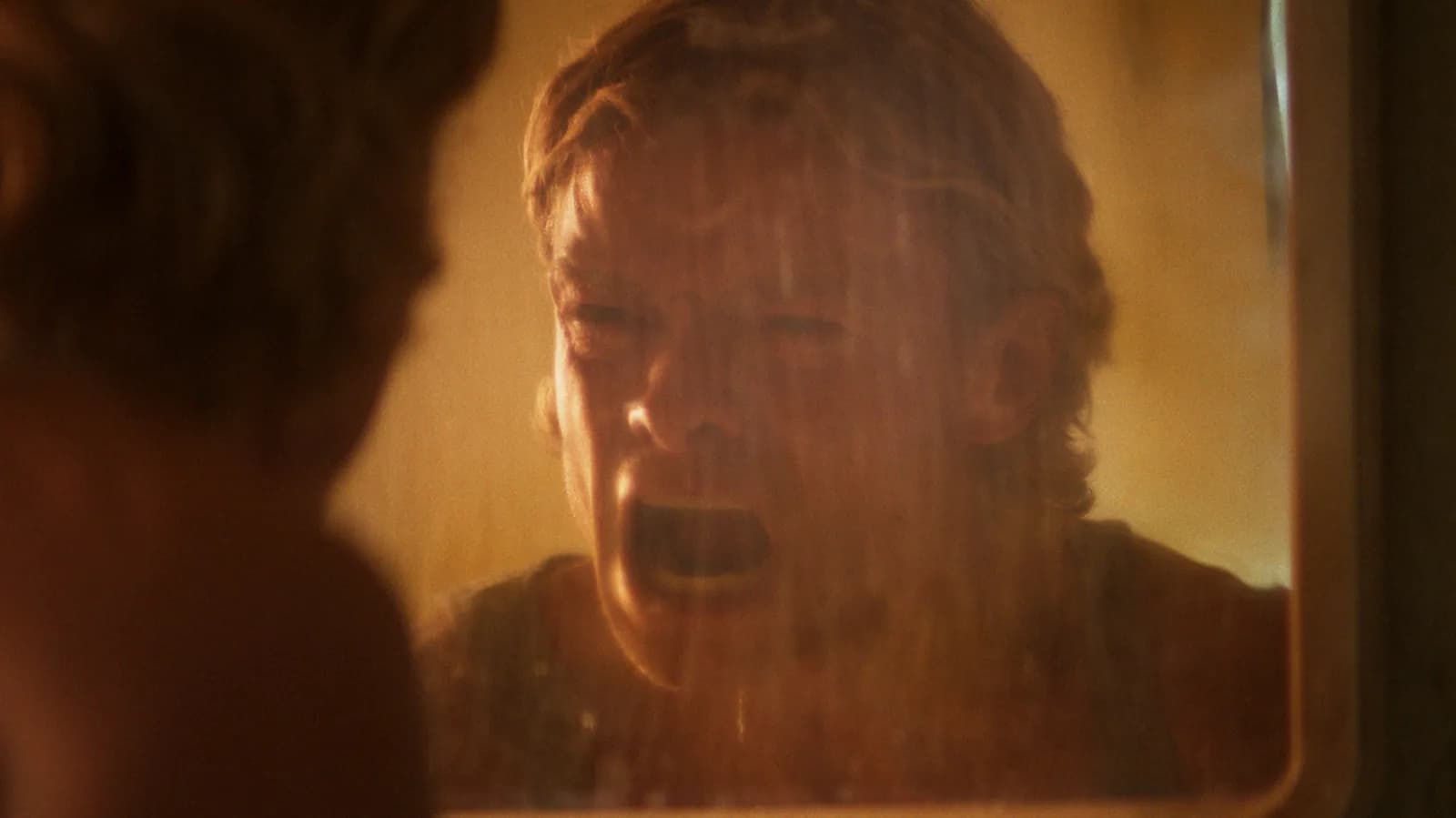 Tom Rhys Harries as Clayface mid-shape-shift in a dimly lit nightclub, surrounded by attackers