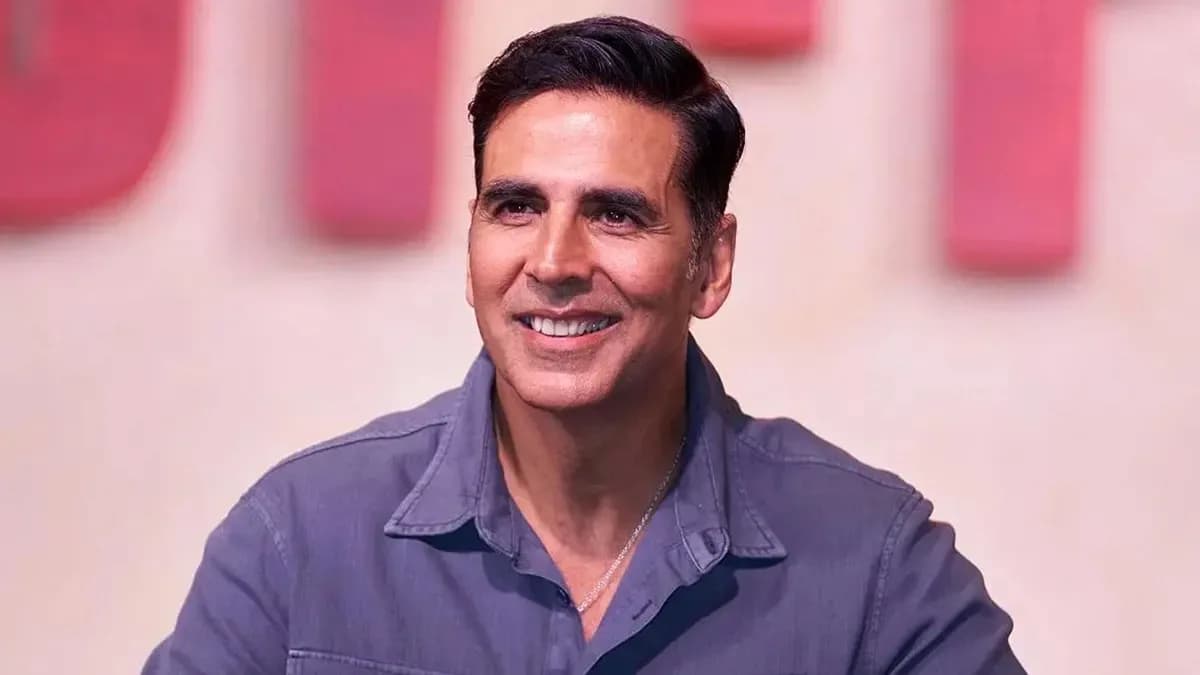 Akshay Kumar in a vibrant outfit, mid-dance, surrounded by elaborate sets in Dehradun
