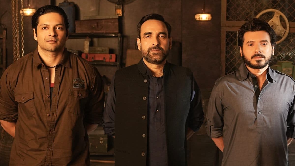 Poster or still from Mirzapur The Movie featuring the main cast against the film's rustic backdrop