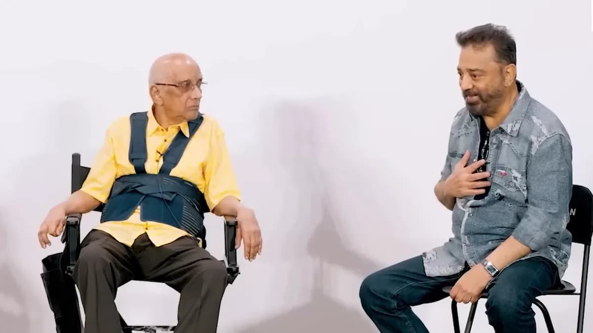 Kamal Haasan and Singeetham Srinivasa Rao standing together on a film set, smiling at the camera.