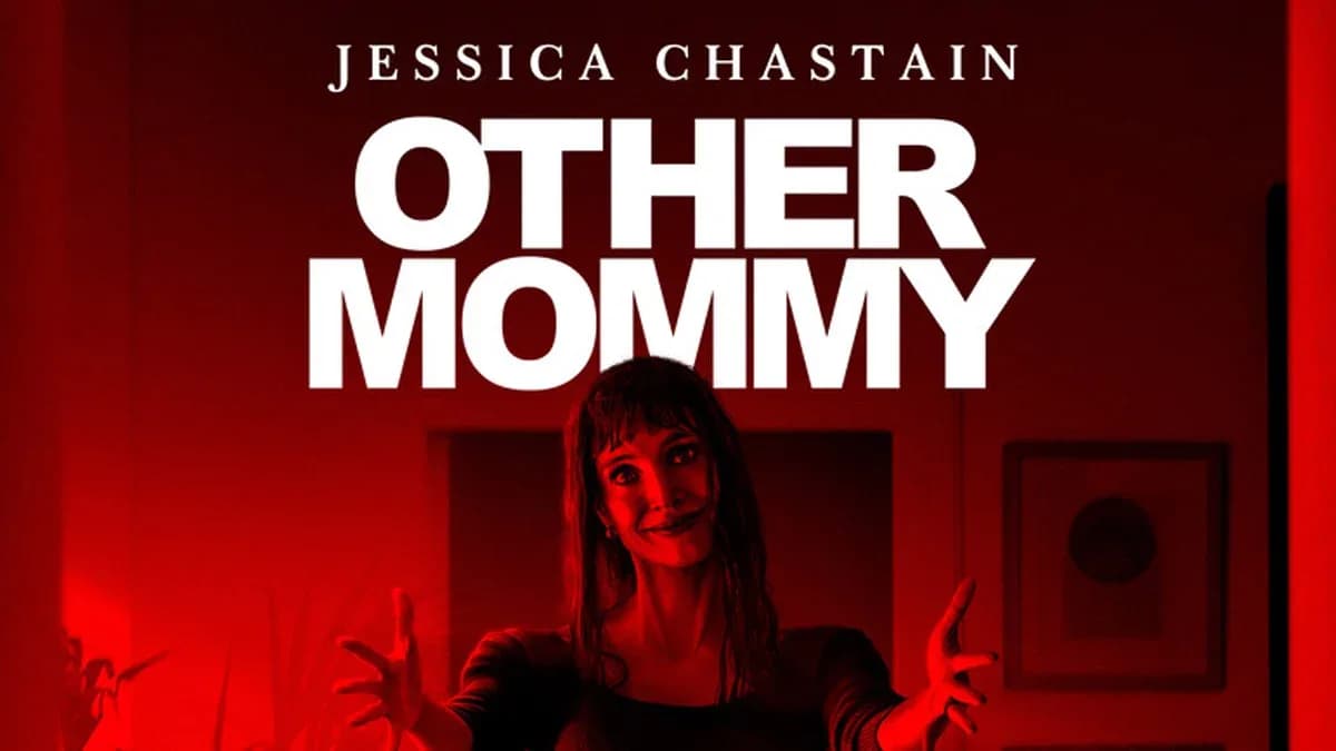 Jessica Chastain in a tense scene from 'Other Mommy', standing in a dimly lit hallway, looking over her shoulder.