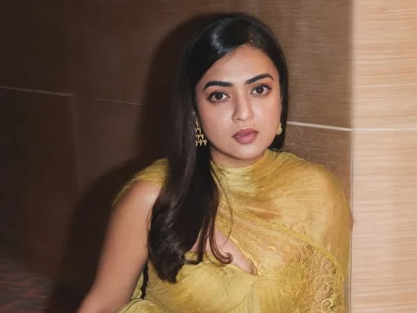 Nazriya Nazim in a black off-shoulder dress at a promotional event in Dubai, posing confidently