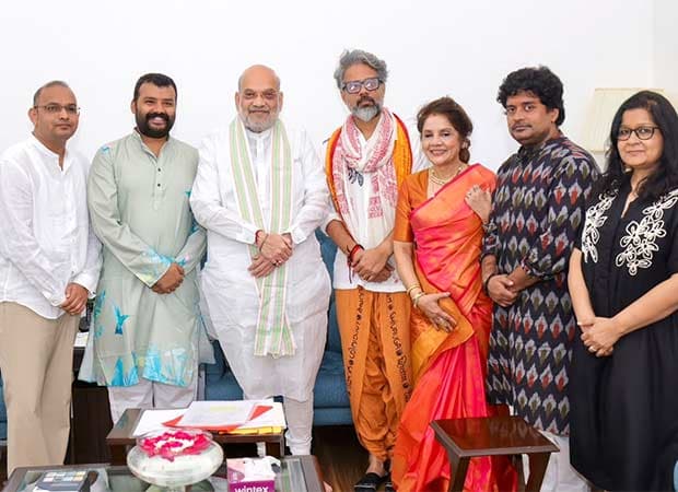 Vishal Chaturvedi and Mahaveer Jain shaking hands with Home Minister Amit Shah at his New Delhi residence