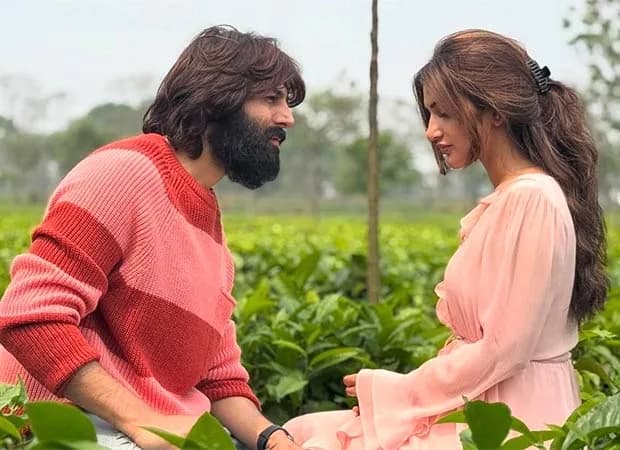 Promotional image of Kartik Aaryan in a rockstar look holding a guitar alongside Sreeleela for their upcoming Anurag Basu film