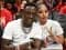 Rapper Boosie posing with fiancée Rajel Nelson and their daughter Sevyn at an LSU Tigers football game