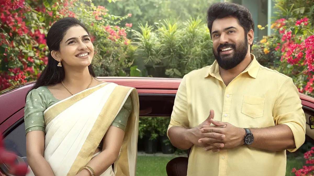 A still from Bethlehem Kudumba Unit featuring Nivin Pauly and Mamitha Baiju in a romantic scene
