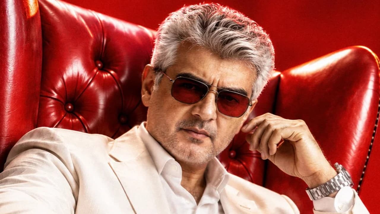 First-look poster of Ajith Kumar in a white outfit sitting on a red chair holding a die for the film Dare Devil