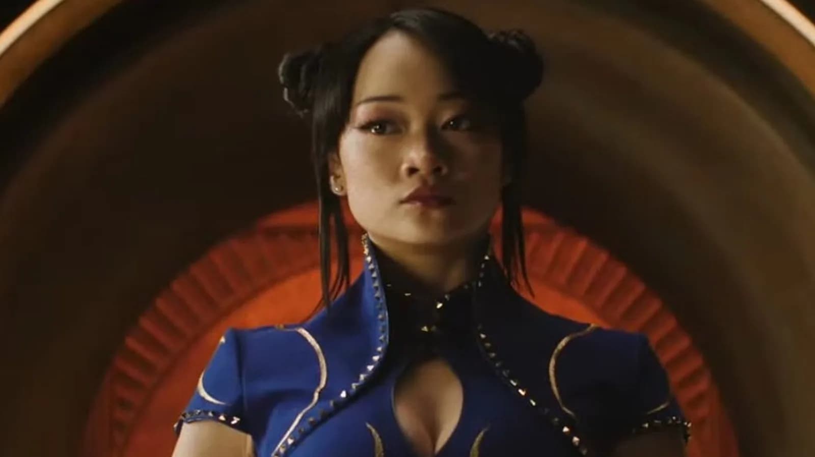 Callina Liang as Chun-Li in the new Street Fighter movie, mid-combat pose, glowing energy around her fists.