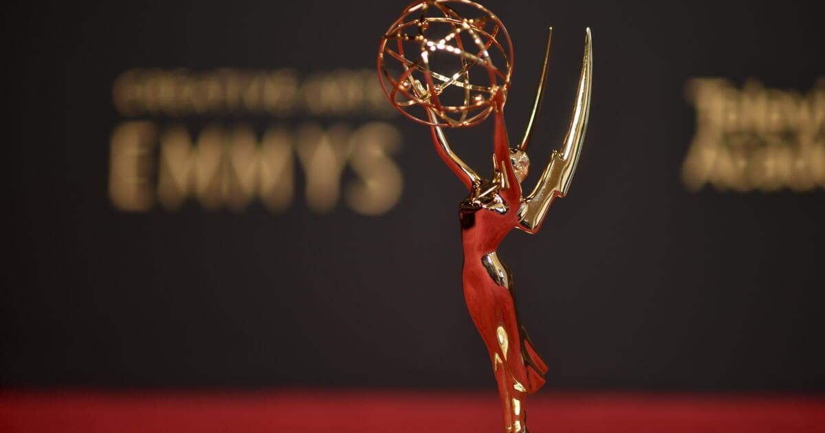 An Emmy Award statuette on stage lighting, symbolic of the television awards ceremony