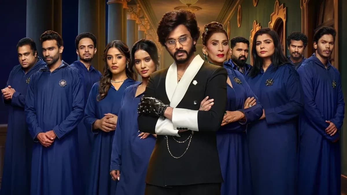 A still from The Traitors Telugu trailer showing contestants in tense close-ups, eyes narrowed, faces half-lit.