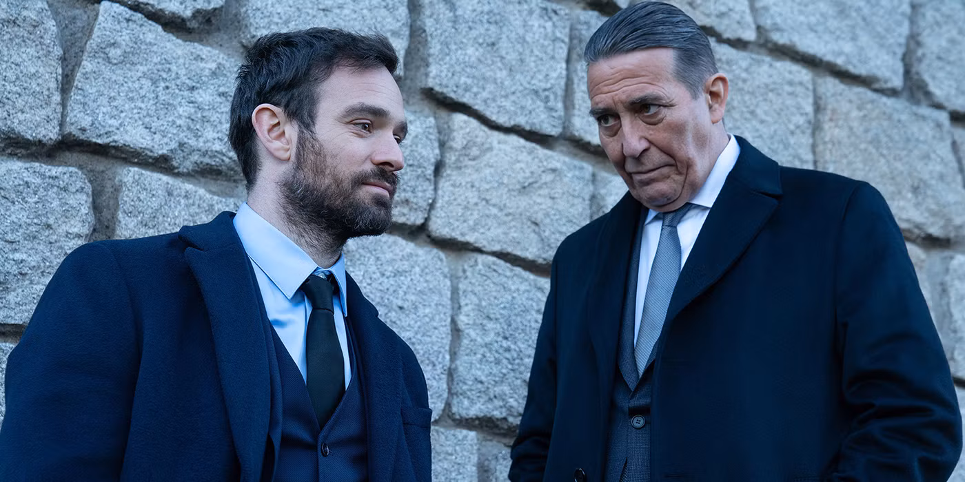 Charlie Cox as Michael Kinsella in Kin, standing in a dimly lit Dublin street, looking tense.