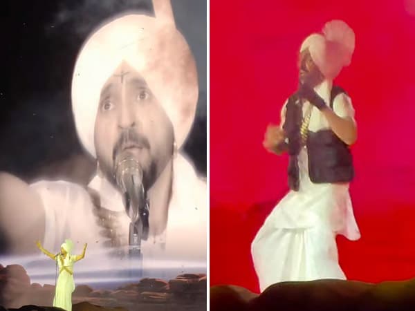 Diljit Dosanjh performing on stage in traditional attire before a large crowd at Wembley Stadium in London.