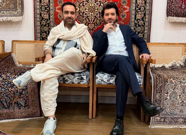 Pankaj Tripathi and Divyenndu seated in character as Kaleen Bhaiya and Munna Bhaiya from Mirzapur: The Movie