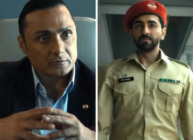 Rahul Bose lying on a hospital bed, eyes wide, a defibrillator pad on his chest, a lift door visible above him. His expression is frozen mid-groan.