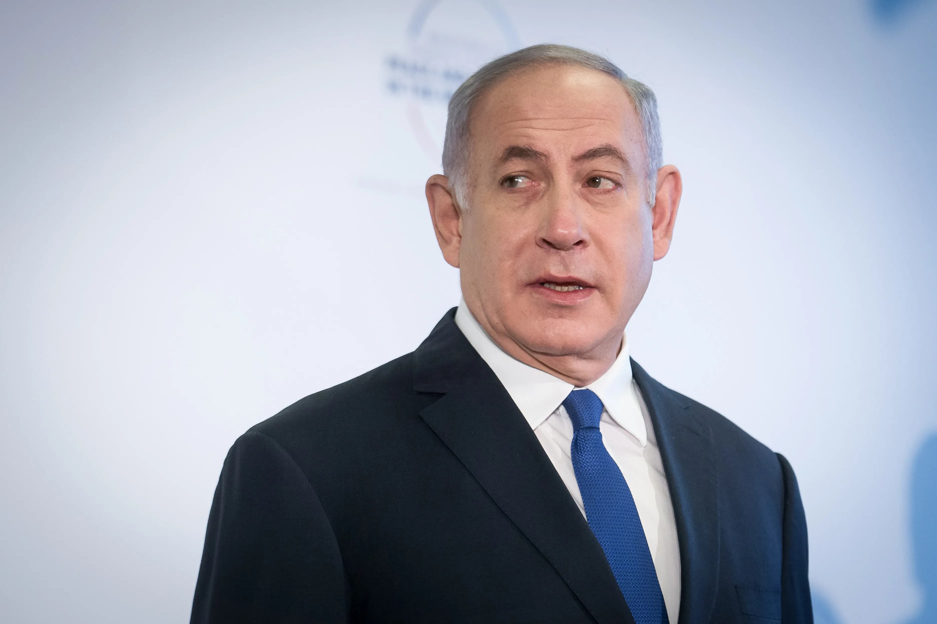 Benjamin Netanyahu speaking at a podium during a press statement