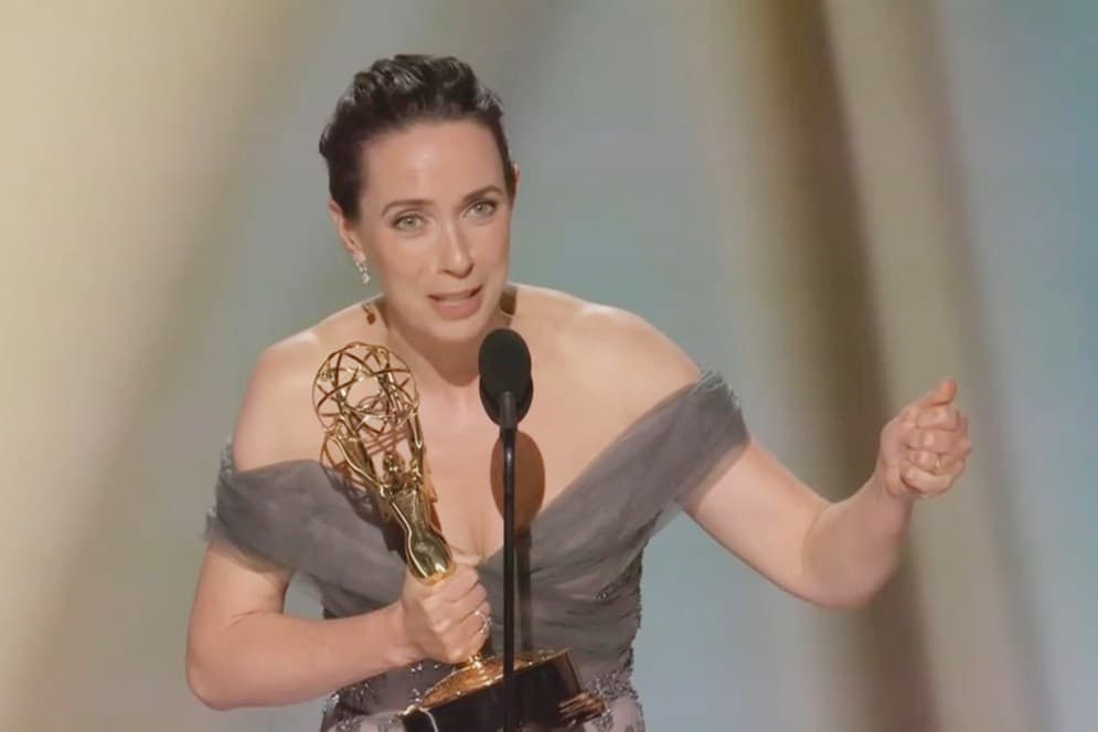 Kate O'Flynn holding her Emmy award on stage at the 76th Primetime Emmy Awards