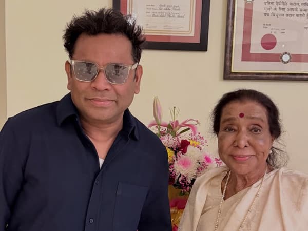 AR Rahman in a recording studio, with an archival photograph of Asha Bhosle displayed nearby.