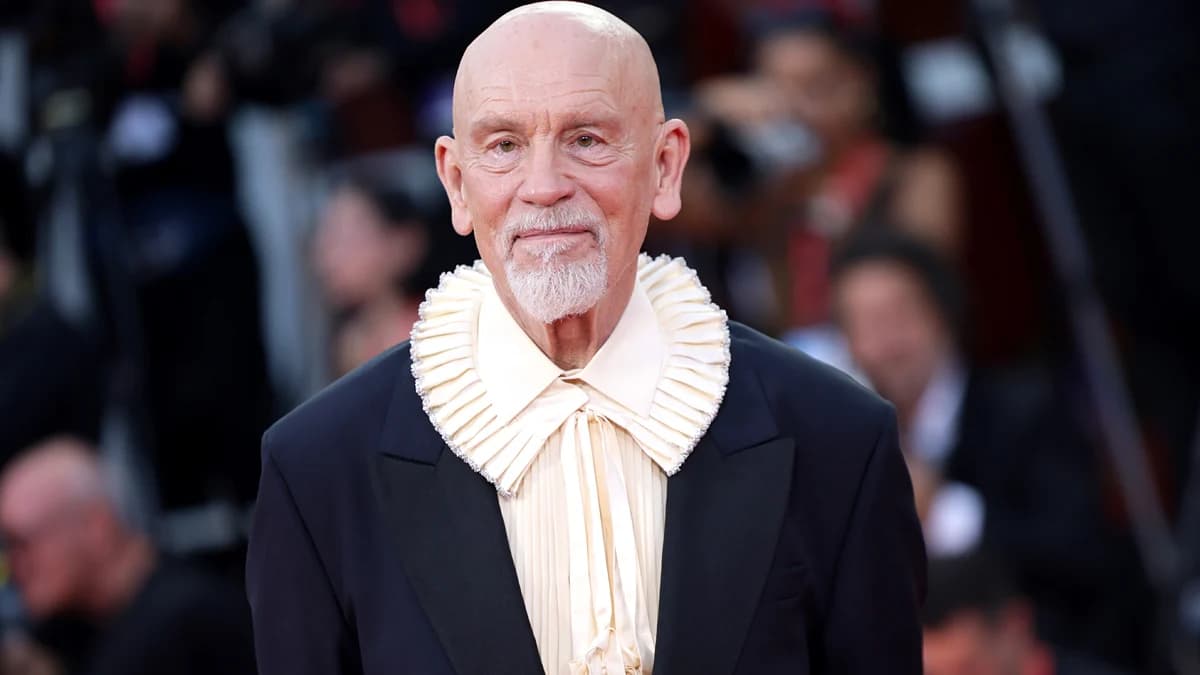 John Malkovich at a public event, looking directly at the camera