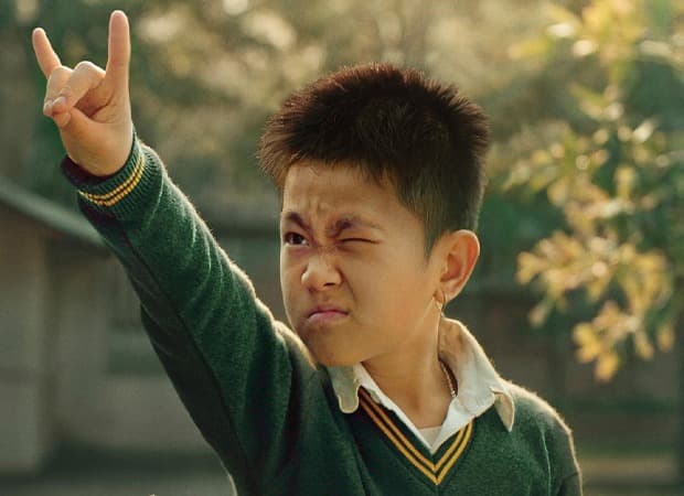 A young boy and his mother stand together in a rural Manipur setting, a still from the film Boong.
