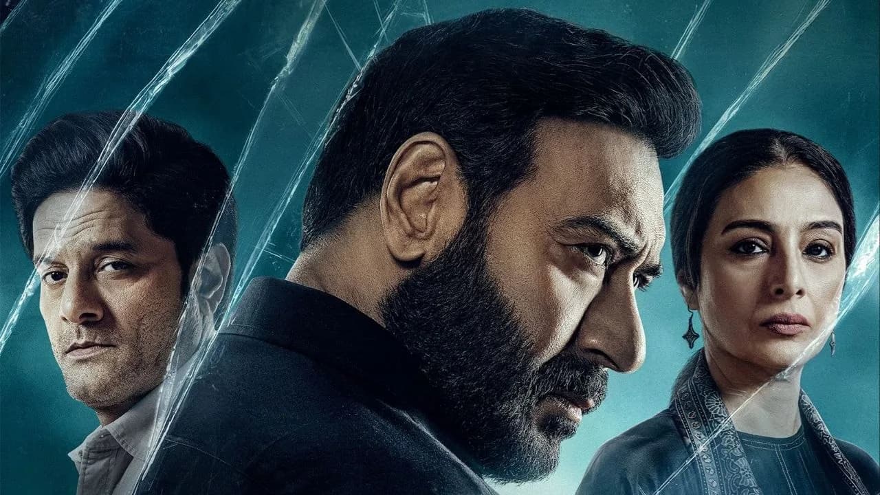 Ajay Devgn as Vijay Salgaonkar in a tense courtroom scene, eyes locked on the camera, expression unreadable.