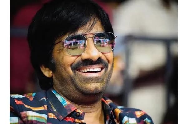 Ravi Teja standing in front of a cinematic backdrop with a subtle title card reading 'Coming Soon' without 'Mass Maharaja' branding.