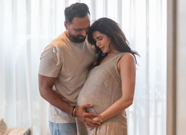 Close-up photograph of Karishma Tanna, Varun Bangera and their newborn son's hands joined together, shared to announce the baby's name.